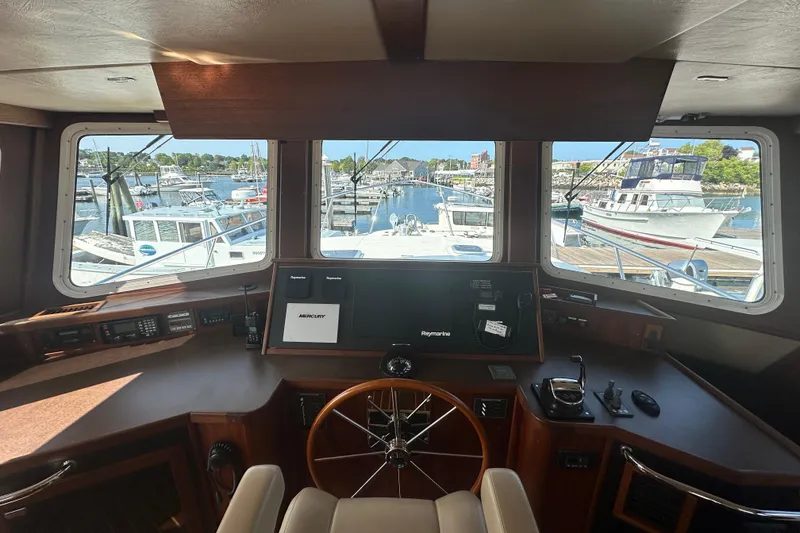 Slide: The Image of Interior of 2006 American Tug 41, featuring wood accents and comfortable seating. - 13