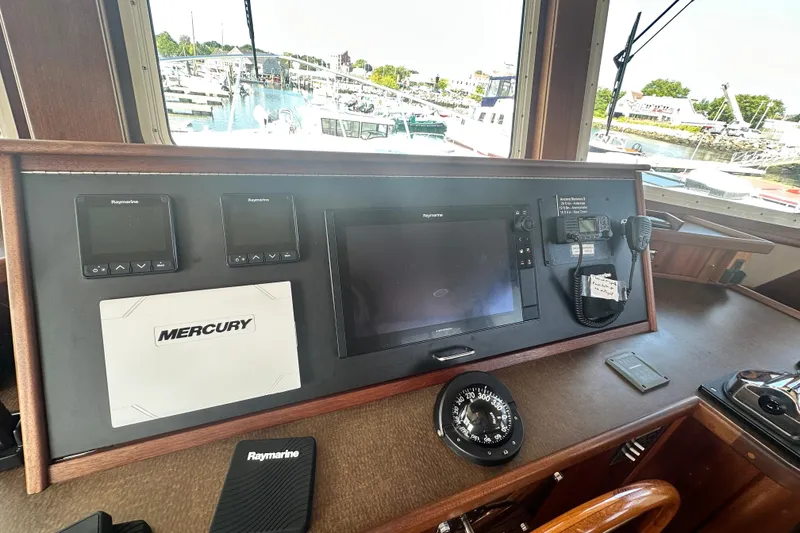 Slide: The Image of Pilothouse of 2006 American Tug 41 with marina view through large windows. - 14