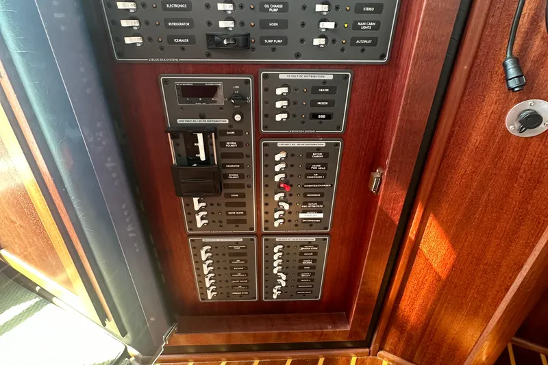 Slide: The Image of Interior view of 2006 American Tug 41, featuring elegant wood paneling and a compass rose design. - 18