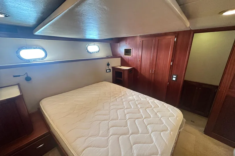 Slide: The Image of Luxurious cabin interior of 2006 American Tug 41 with cozy bed and ambient lighting. - 23