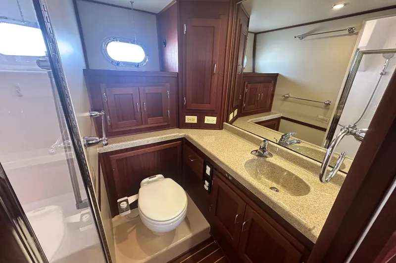 Slide: The Image of Interior of 2006 American Tug 41, featuring wooden cabinetry and drawers in a cozy hallway. - 26