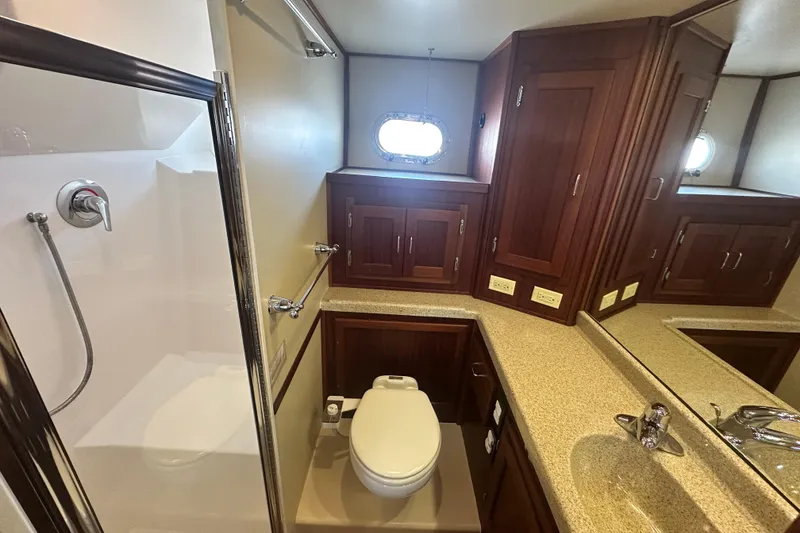 Slide: The Image of Luxurious bathroom in 2006 American Tug 41 with wood cabinetry and modern fixtures. - 27