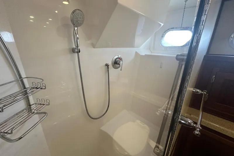 Slide: The Image of Luxurious bathroom in 2006 American Tug 41 with wood cabinetry and modern fixtures. - 28