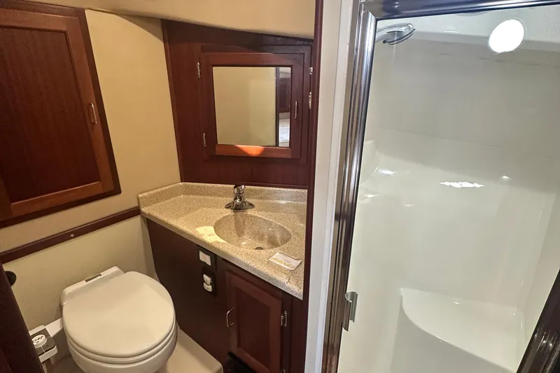 Slide: The Image of Cozy cabin interior of 2006 American Tug 41 with wooden cabinetry and comfortable bed. - 31