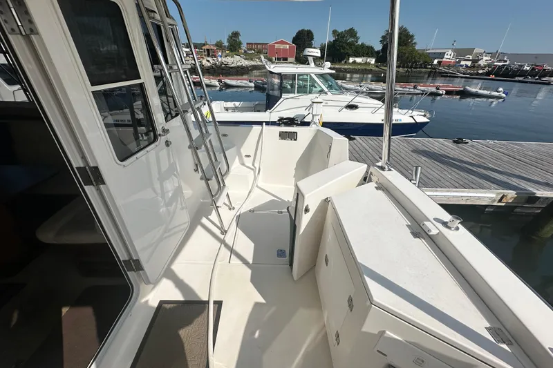 Slide: The Image of 2006 American Tug 41 yacht deck with marina view, featuring ropes and shoes. - 33