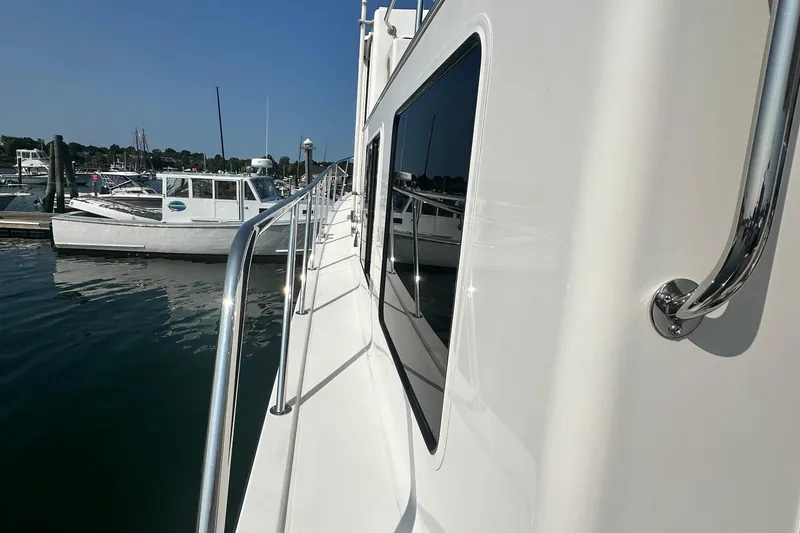 Slide: The Image of Side view of a 2006 American Tug 41 docked at a marina. - 37