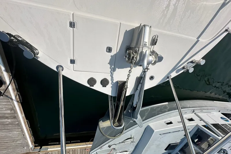 Slide: The Image of 2006 American Tug 41 docked at marina, showcasing spacious deck and surrounding boats. - 42