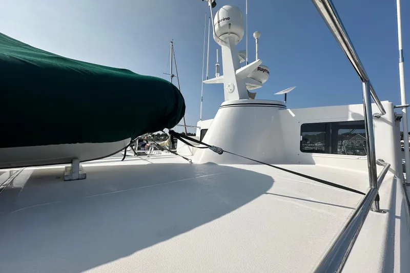 Slide: The Image of 2006 American Tug 41 deck with green-covered equipment, docked at marina. - 44