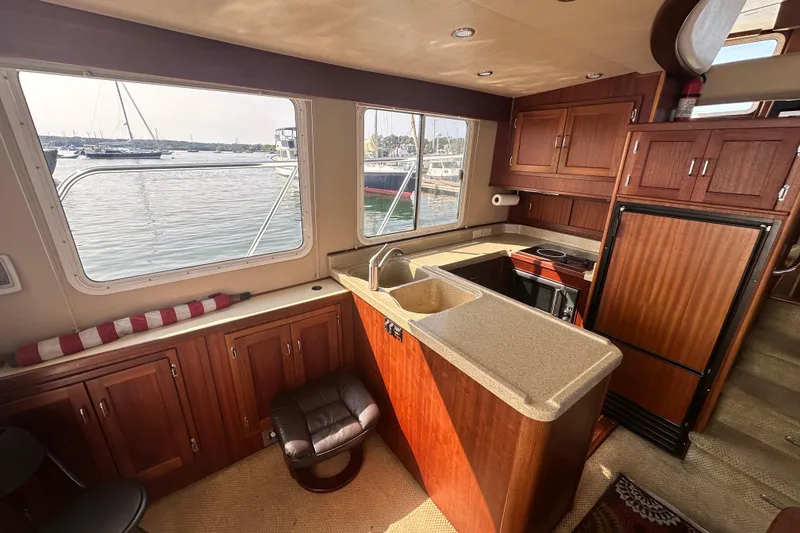 Slide: The Image of Interior of 2006 American Tug 41 with cozy seating and wooden table. - 6