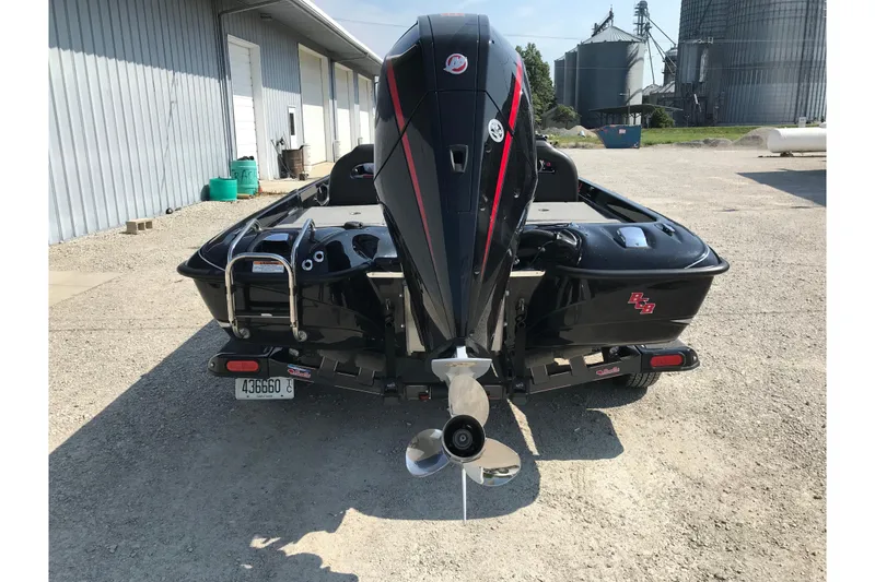 Slide: The Image of 2023 Bass Cat Pantera II boat with powerful outboard motor, parked on gravel. - 22