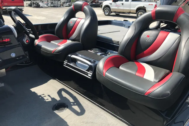 Slide: The Image of 2023 Bass Cat Pantera II boat interior with stylish red and black seats. - 8