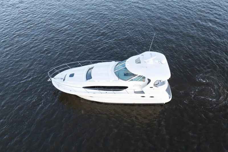 Slide: The Image of 2007 Sea Ray 40 Motor Yacht cruising on open water, aerial view. - 11