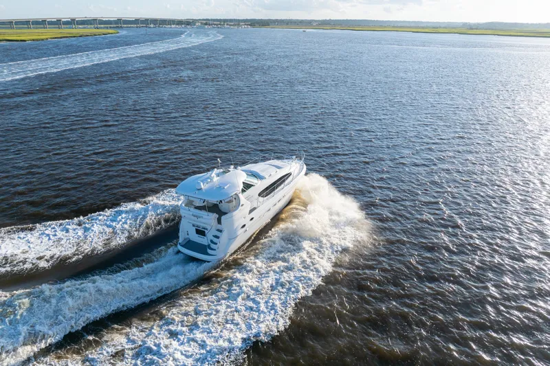 Slide: The Image of 2007 Sea Ray 40 Motor Yacht cruising on open water, leaving a wake behind. - 17