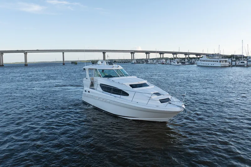 Slide: The Image of 2007 Sea Ray 40 Motor Yacht cruising on a scenic waterway near a bridge. - 18