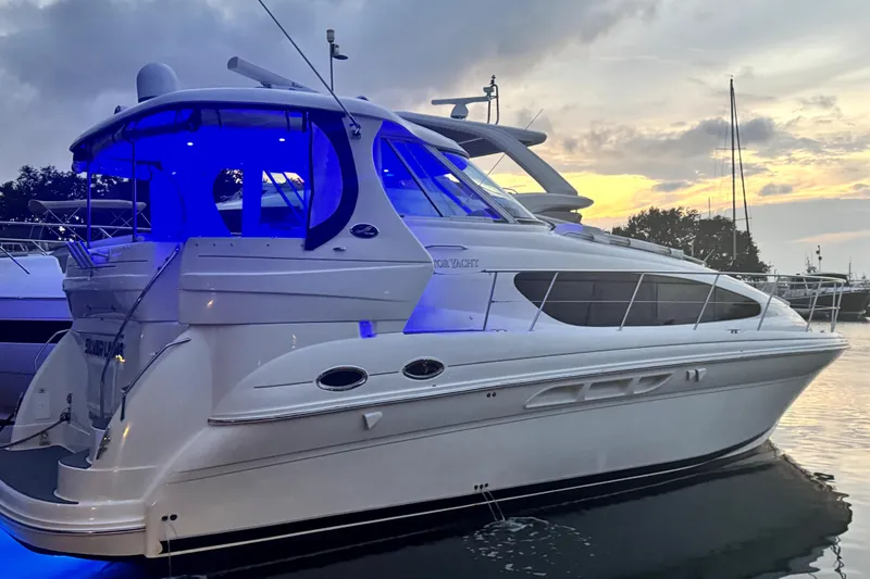 Slide: The Image of 2007 Sea Ray 40 Motor Yacht at sunset with blue interior lighting. - 2