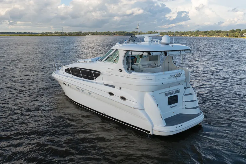 Slide: The Image of 2007 Sea Ray 40 Motor Yacht cruising on a calm lake under a cloudy sky. - 20