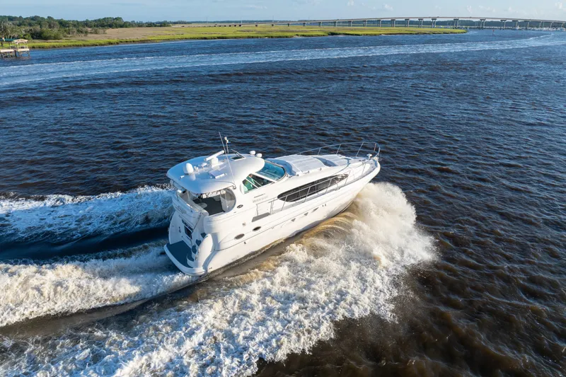 Slide: The Image of 2007 Sea Ray 40 Motor Yacht cruising on a river with scenic background. - 23