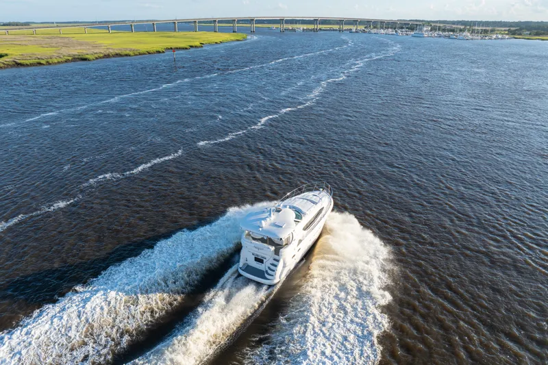 Slide: The Image of 2007 Sea Ray 40 Motor Yacht cruising on a wide river near a bridge. - 28