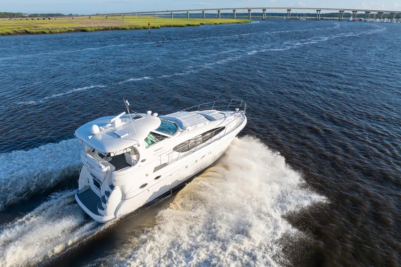 Slide: The Image of 2007 Sea Ray 40 Motor Yacht cruising on open water near a bridge. - 29