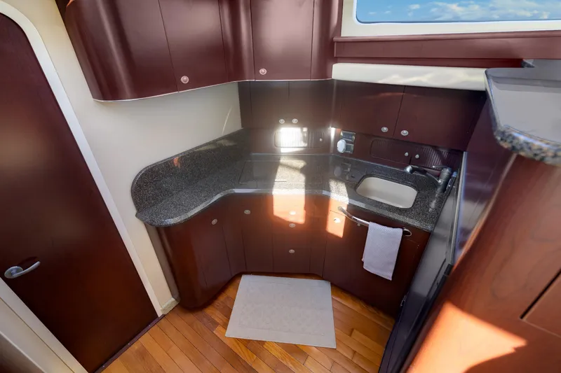 Slide: The Image of Luxurious kitchen interior of 2007 Sea Ray 40 Motor Yacht with wooden cabinetry. - 36