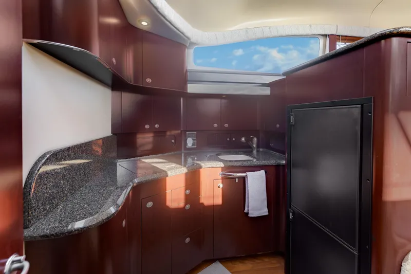 Slide: The Image of Luxurious 2007 Sea Ray 40 Motor Yacht kitchen with sleek cabinetry and granite countertops. - 37