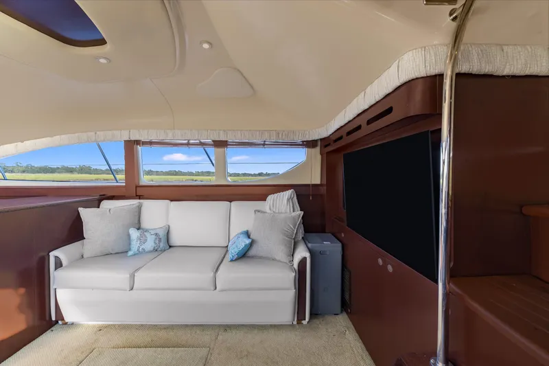 Slide: The Image of Luxurious interior of 2007 Sea Ray 40 Motor Yacht with sofa and large windows. - 42
