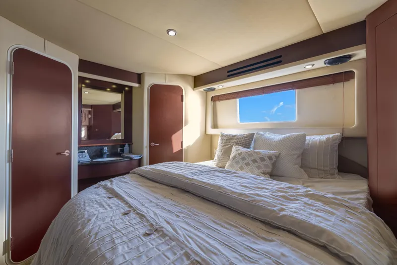 Slide: The Image of Luxurious bedroom interior of 2007 Sea Ray 40 Motor Yacht with elegant bedding and window view. - 43