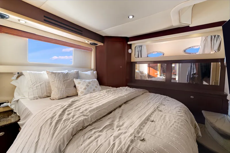 Slide: The Image of Luxurious bedroom interior of 2007 Sea Ray 40 Motor Yacht with elegant bedding and windows. - 47