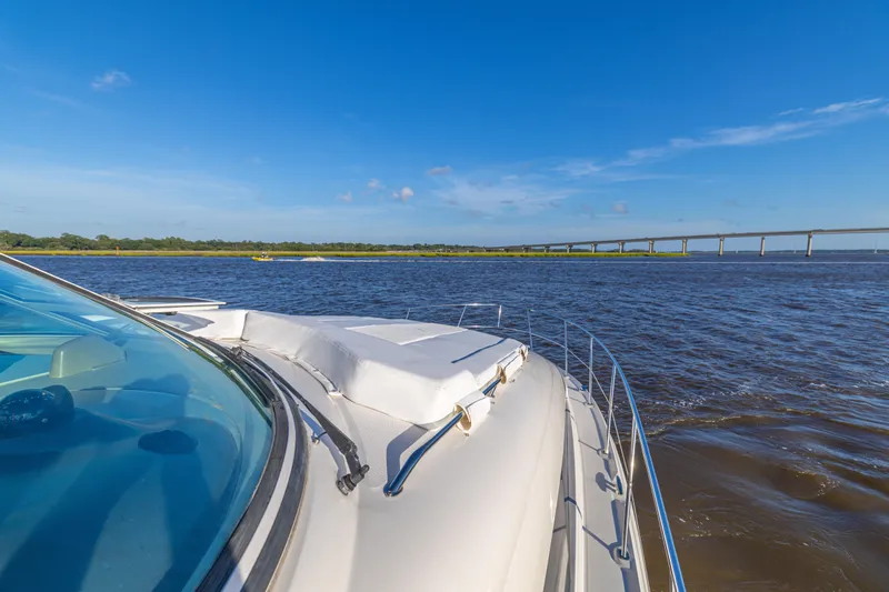 Slide: The Image of 2007 Sea Ray 40 Motor Yacht cruising on a sunny day near a bridge. - 53