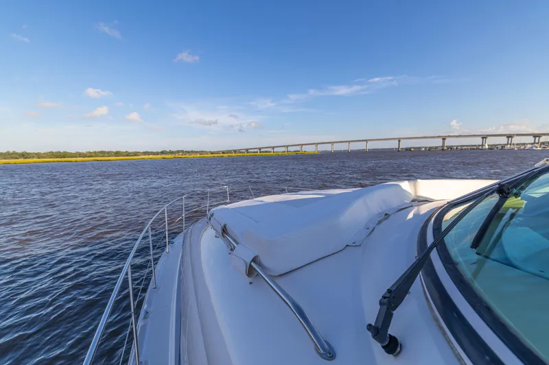 Slide: The Image of 2007 Sea Ray 40 Motor Yacht cruising on a sunny day with bridge in background. - 56