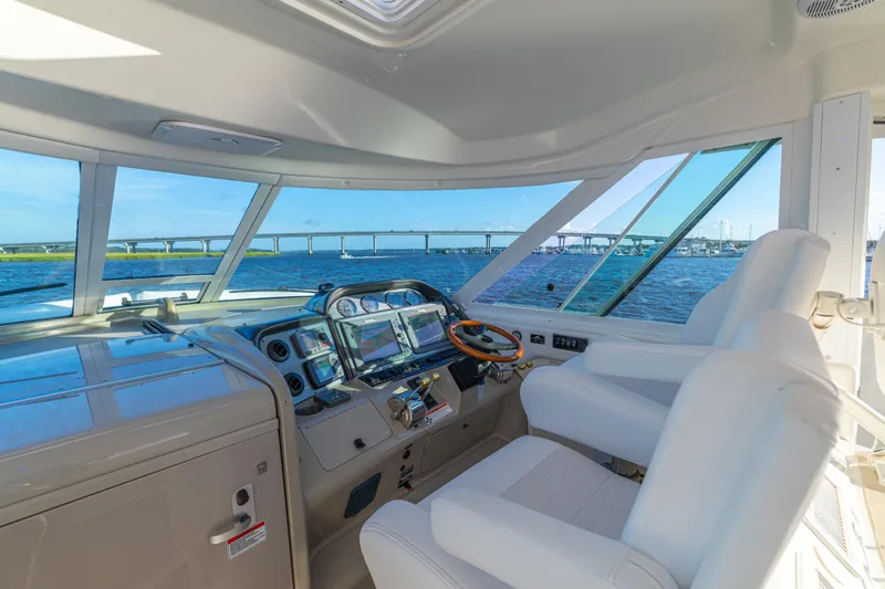 Slide: The Image of Interior view of 2007 Sea Ray 40 Motor Yacht helm with water and bridge in background. - 60