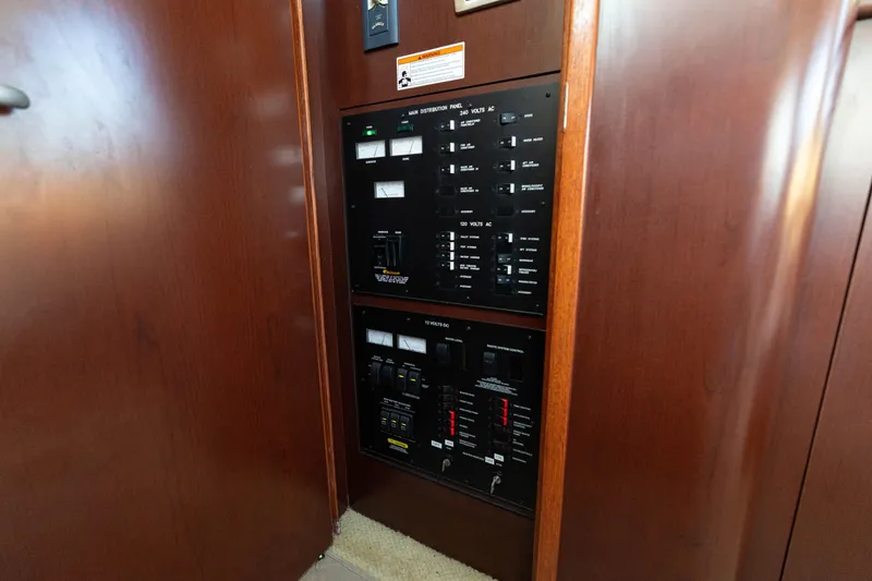 Slide: The Image of Electrical control panel inside 2007 Sea Ray 40 Motor Yacht with wooden finish. - 65