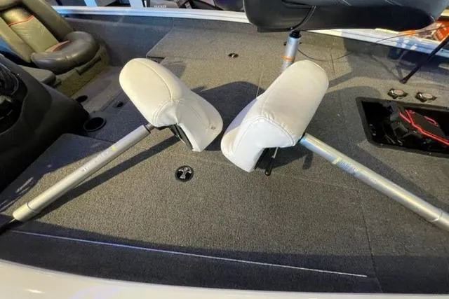 Slide: The Image of 2022 Tracker Pro Team 175 TXW boat interior with two white seats on gray carpet. - 18