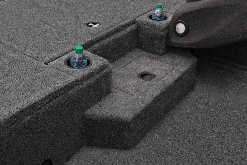 Slide: The Image of 2022 Tracker Pro Team 175 TXW boat interior with cup holders and carpeted flooring. - 25