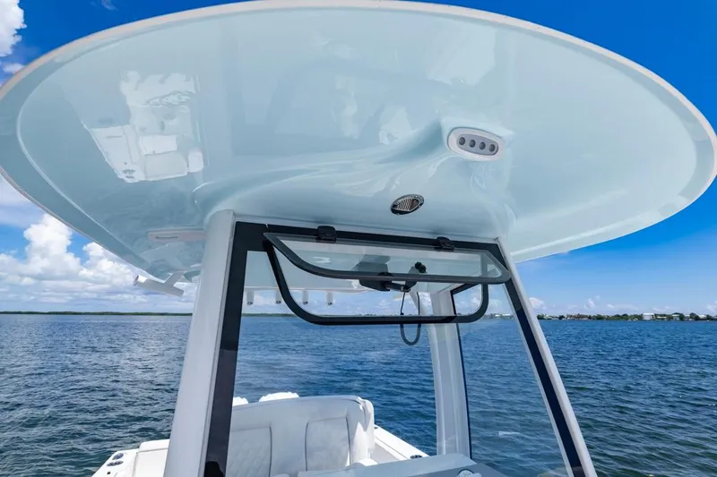 Slide: The Image of 2026 Sea Hunt Gamefish 27 Coffin Box boat on open water under clear blue sky. - 12