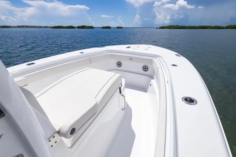 Slide: The Image of 2026 Sea Hunt Gamefish 27 Coffin Box boat on calm water, clear sky. - 13