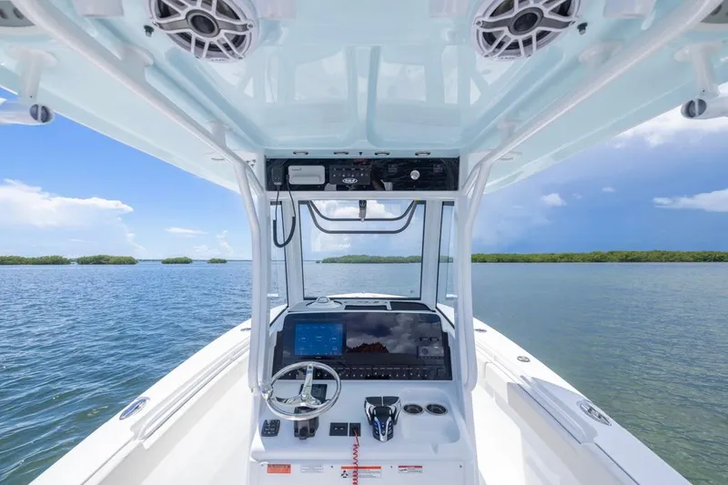 Slide: The Image of 2026 Sea Hunt Gamefish 27 Coffin Box boat interior with advanced navigation system on open water. - 15