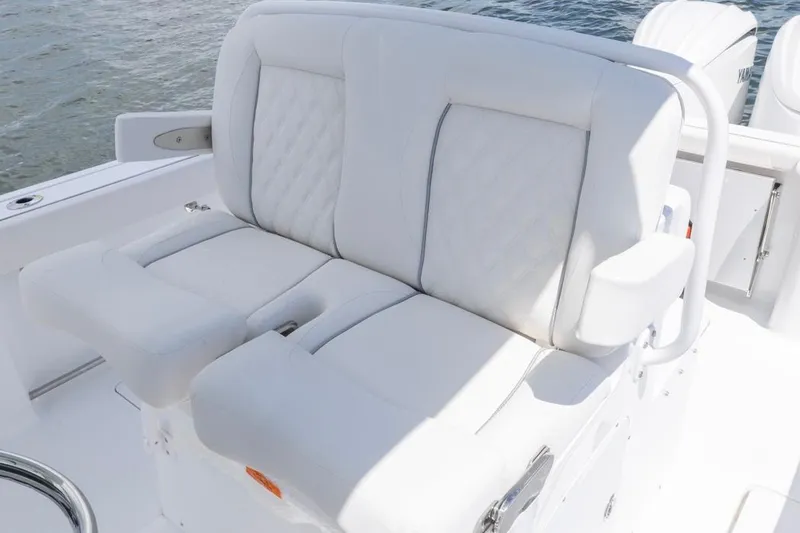 Slide: The Image of 2026 Sea Hunt Gamefish 27 Coffin Box boat seating, white upholstery, on water. - 18