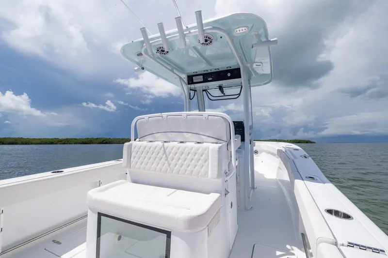 Slide: The Image of 2026 Sea Hunt Gamefish 27 Coffin Box boat on calm waters under cloudy sky. - 20