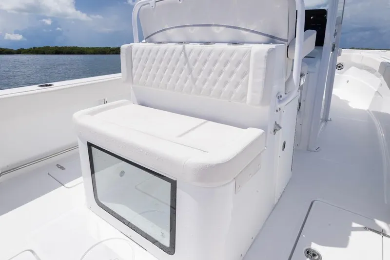 Slide: The Image of 2026 Sea Hunt Gamefish 27 Coffin Box boat interior with white seating and storage. - 21