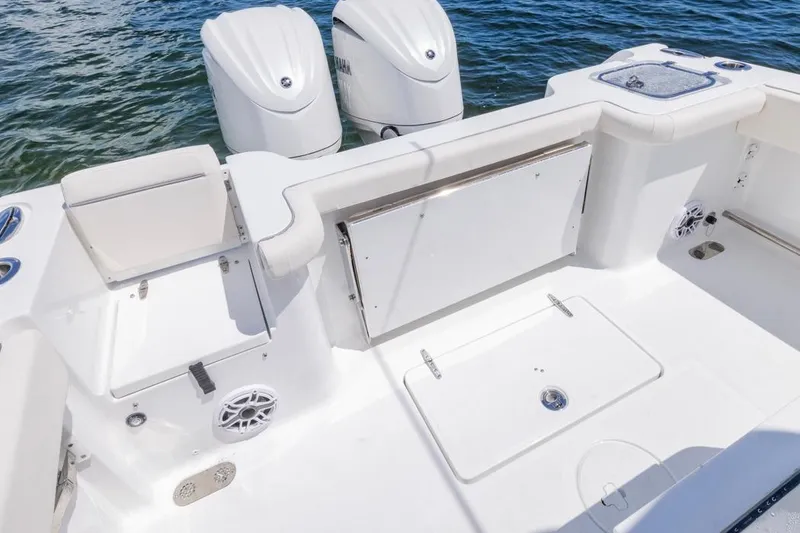 Slide: The Image of 2026 Sea Hunt Gamefish 27 Coffin Box boat interior with dual engines and seating. - 25