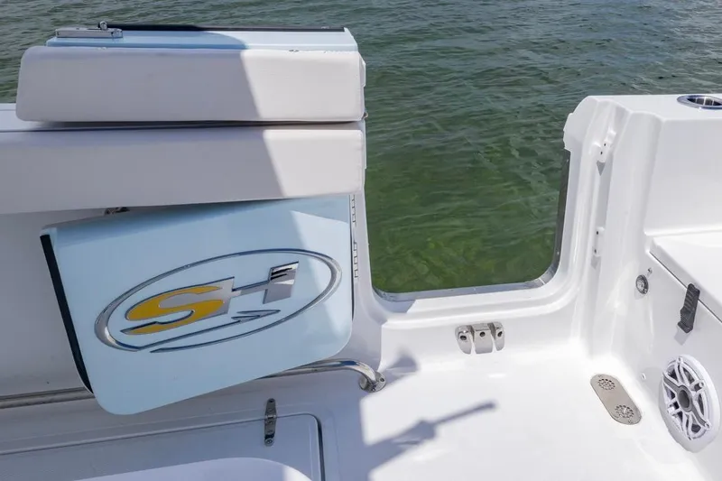 Slide: The Image of 2026 Sea Hunt Gamefish 27 Coffin Box boat interior with open hatch and water view. - 28