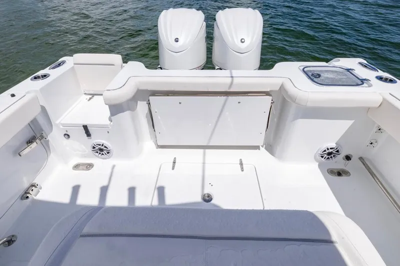 Slide: The Image of 2026 Sea Hunt Gamefish 27 Coffin Box boat interior with dual engines and seating. - 31