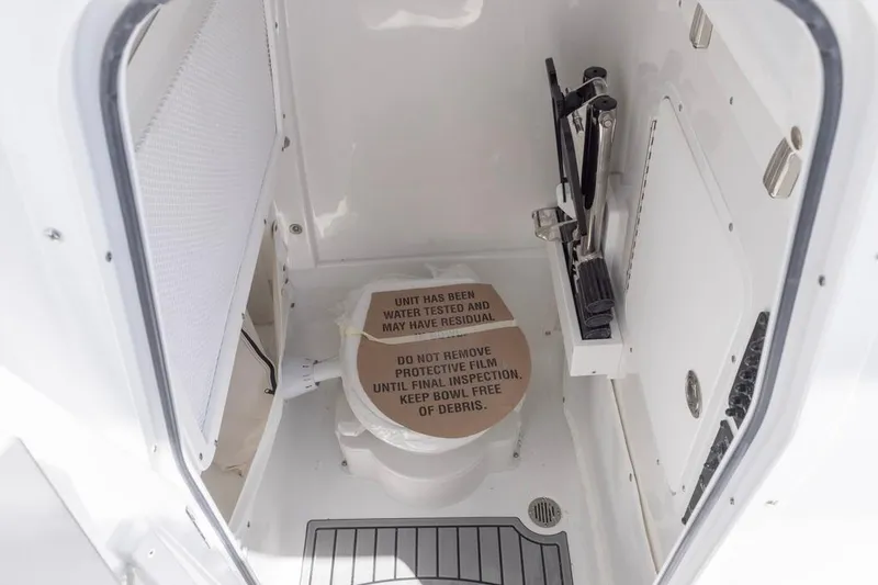 Slide: The Image of 2026 Sea Hunt Gamefish 27 Coffin Box boat interior with toilet and protective film. - 32
