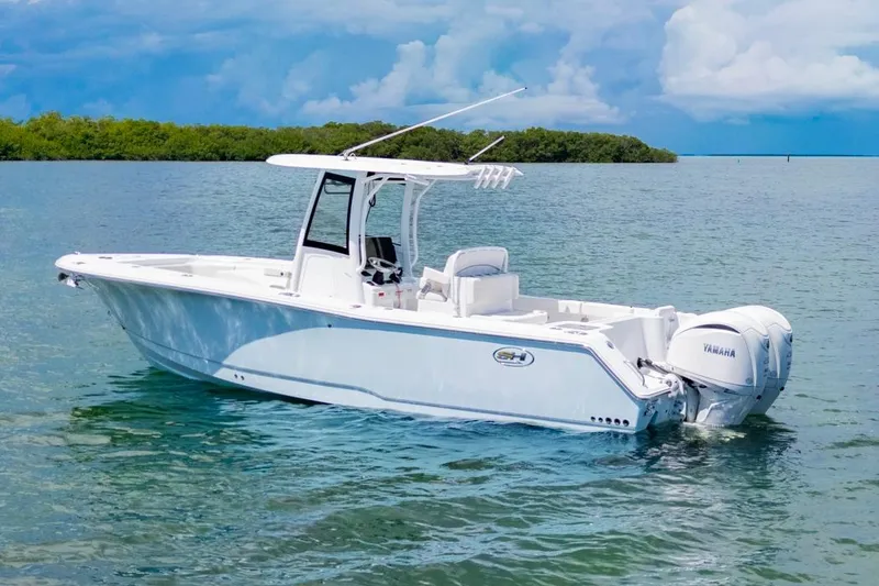 Slide: The Image of 2026 Sea Hunt Gamefish 27 Coffin Box boat on calm water, featuring Yamaha engines. - 35