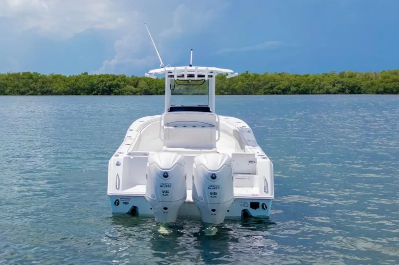 Slide: The Image of 2026 Sea Hunt Gamefish 27 Coffin Box boat on calm water, rear view. - 4