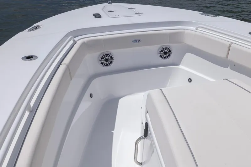 Slide: The Image of 2026 Sea Hunt Gamefish 27 Coffin Box boat interior with cushioned seating and speakers. - 5
