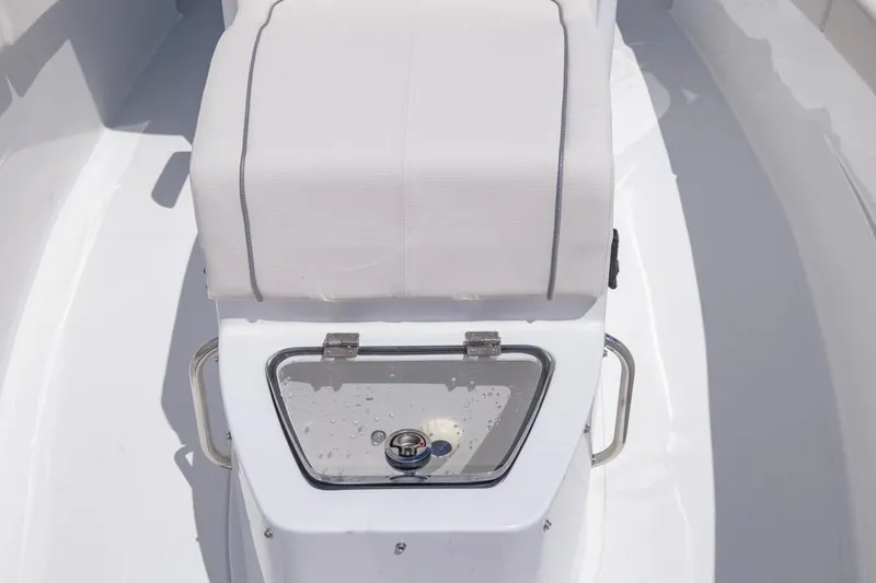 Slide: The Image of 2026 Sea Hunt Gamefish 27 Coffin Box interior with white seating and storage compartment. - 8