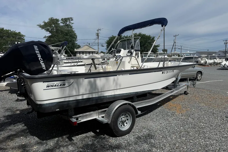 Slide: The Image of 2007 Boston Whaler 190 Montauk boat on trailer, parked outdoors. - 1