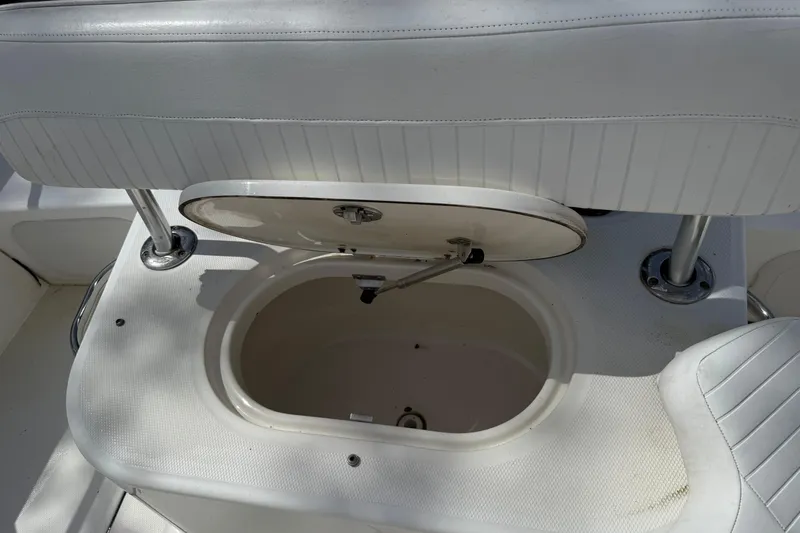 Slide: The Image of 2007 Boston Whaler 190 Montauk boat seat with open storage compartment. - 10